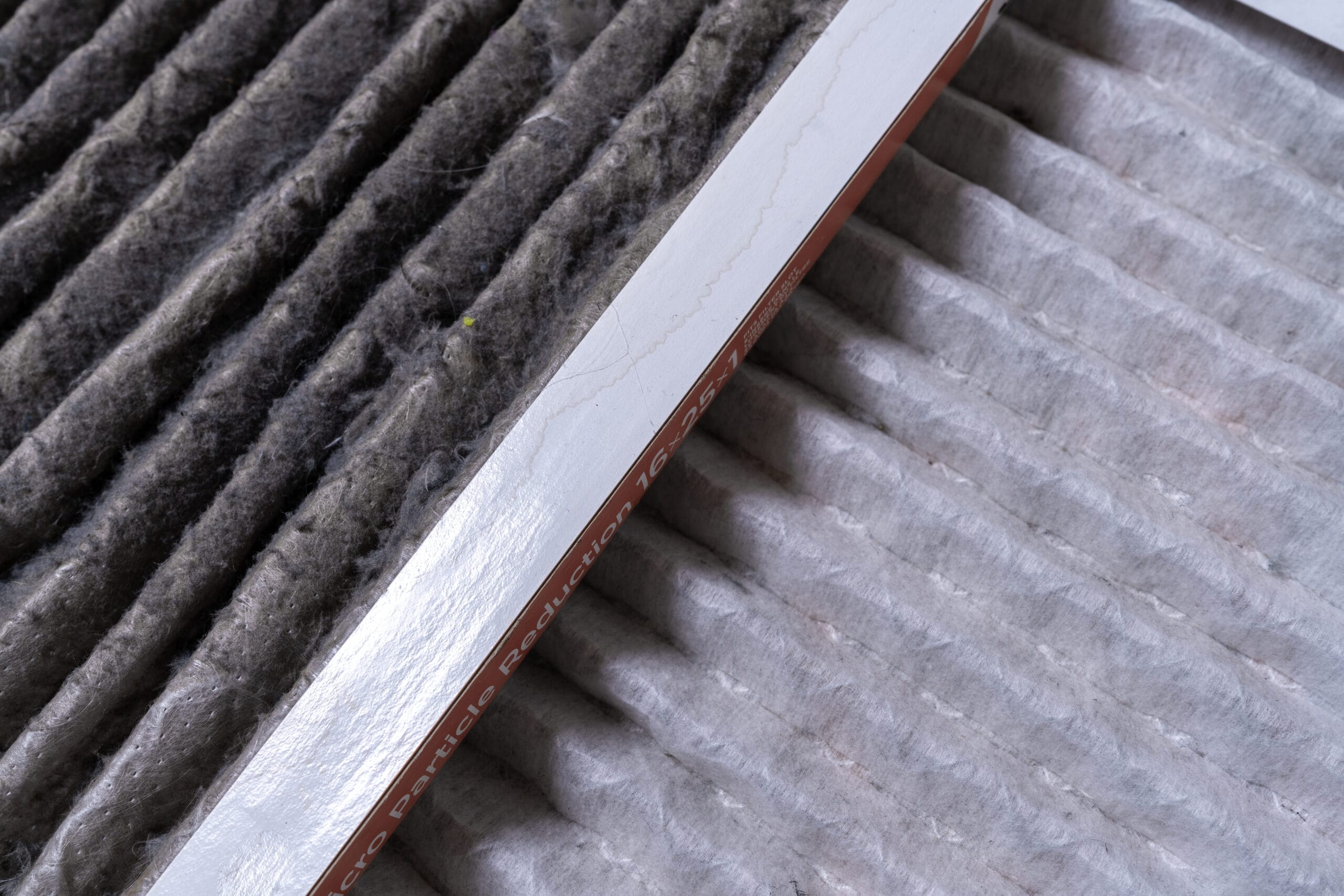 Close-up of pleated air filters that are dirty and clean