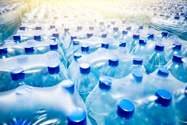 Many packaged blue plastic water bottles ready for shipment